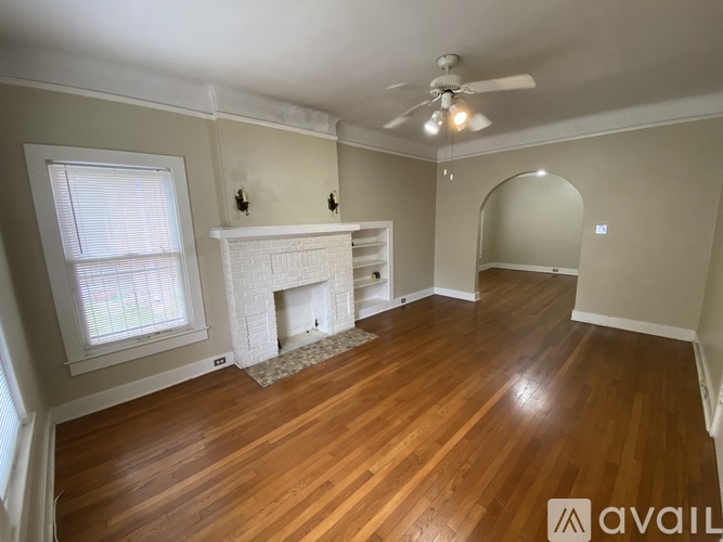 A room with a fireplace and a ceiling fan.