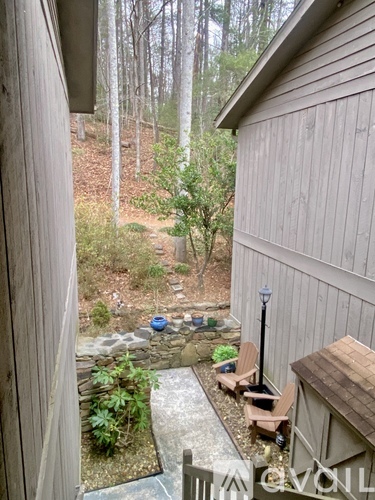 A small patio area with a table and chairs is visible from a doorway.
