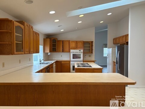 A kitchen with wooden cabinets and a central island.