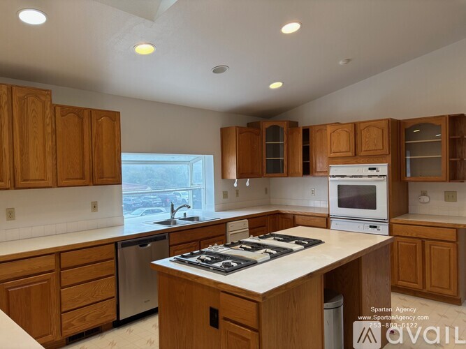 A kitchen with wooden cabinets and a white countertop.