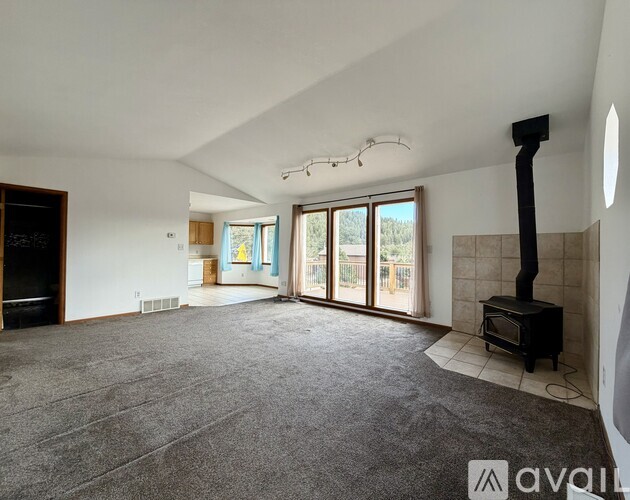 A spacious living room with a fireplace and sliding glass doors.