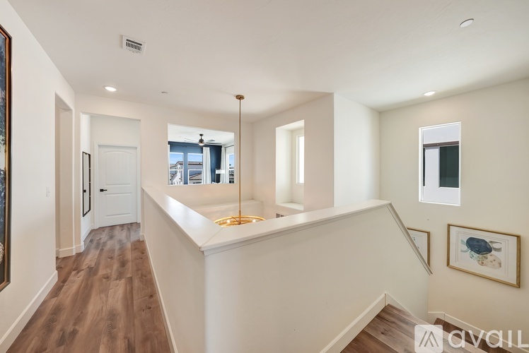 A spacious interior of a house with a staircase leading to the upper floor.