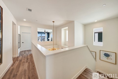 A spacious interior of a house with a staircase leading to the upper floor.