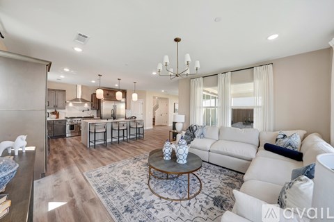 A spacious living room with a white sofa and a coffee table.