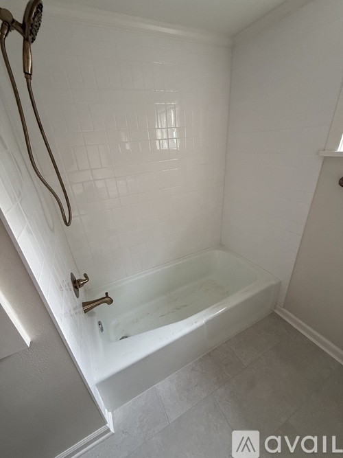 A white bathroom with a tub and shower.
