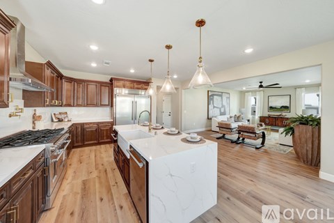 A modern kitchen with wooden cabinets and a white island.