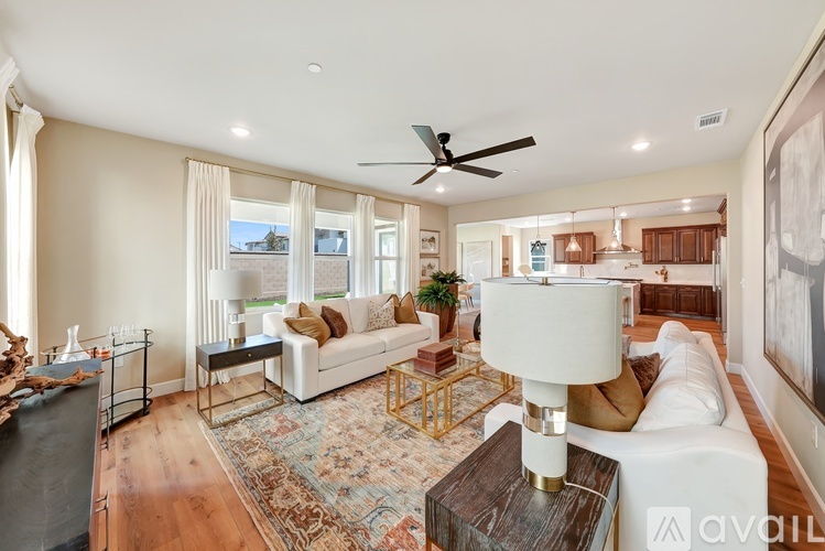 A living room with a white couch and a rug.