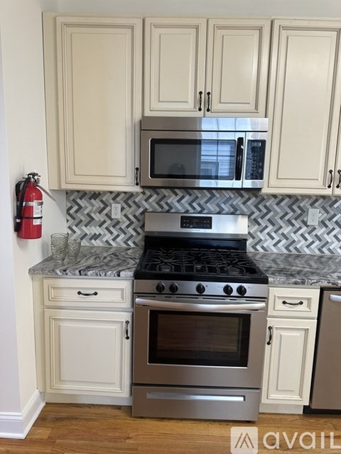 A kitchen with a stove top oven and microwave above it.
