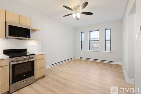 A kitchen with a stove, oven, and microwave.