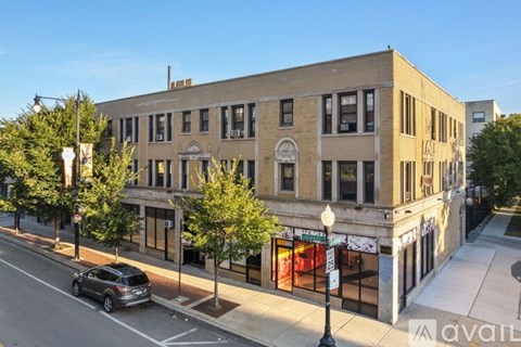 A street view of a building with a car parked in front.