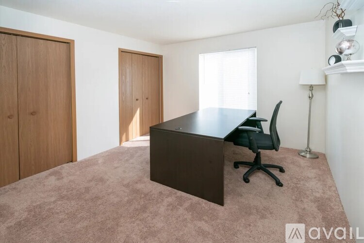 A room with a desk and a chair.