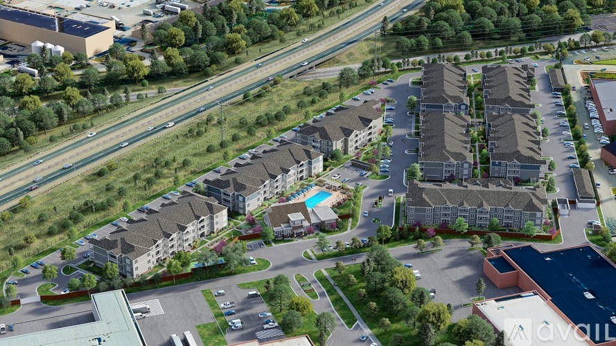 An aerial view of a large residential complex with multiple buildings and a swimming pool.