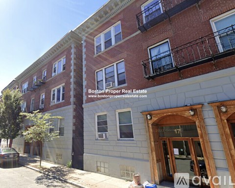 A building with a balcony on the second floor.