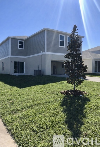 A house with a tree in front of it.