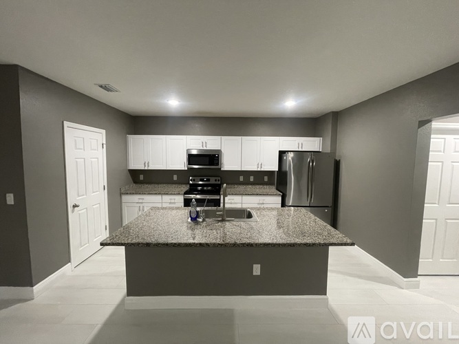A kitchen with granite countertops and stainless steel appliances.