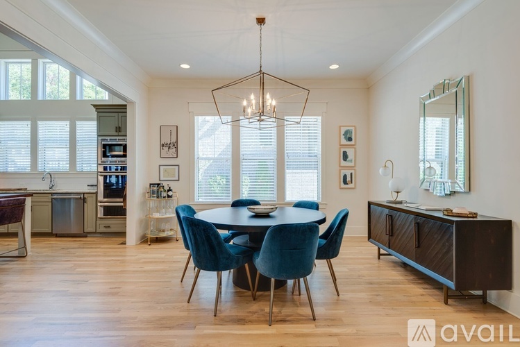 A modern dining room with a large table and chairs.