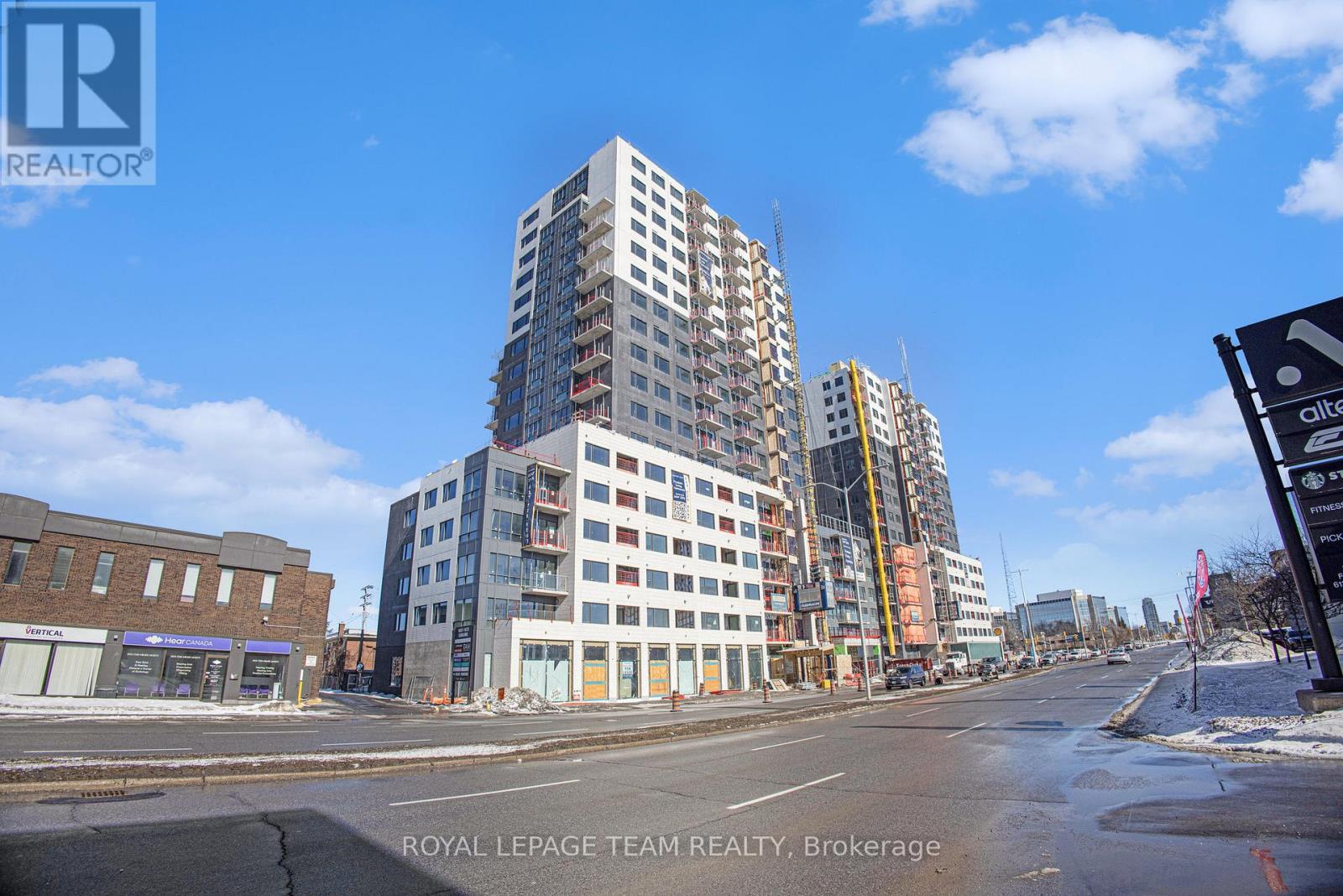 A tall building under construction is the focal point of the image.