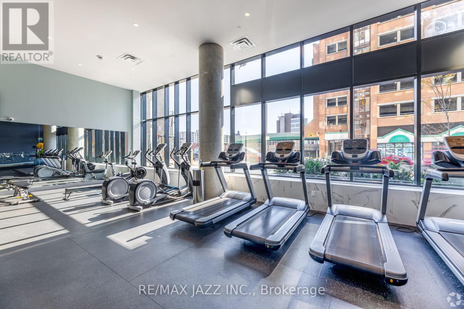 A gym with treadmills and elliptical machines.