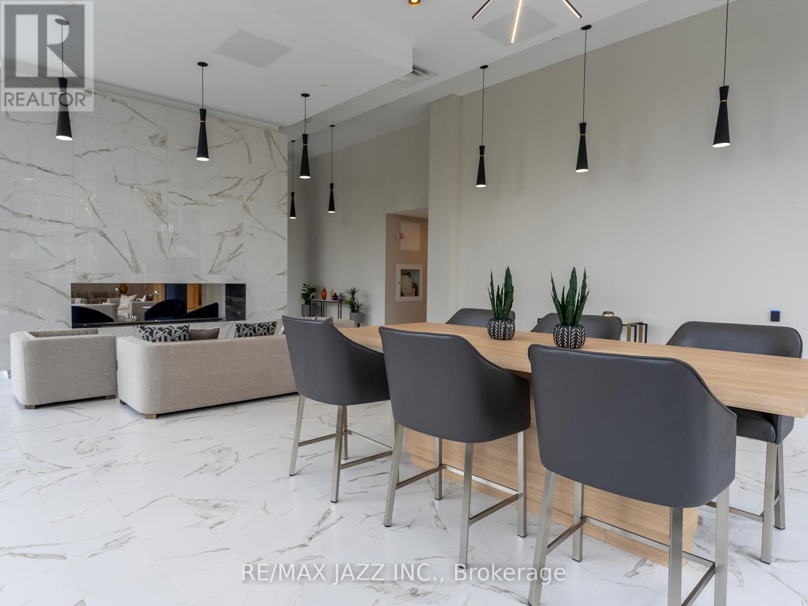 A modern dining room with a marble floor and a large table with chairs.