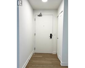 A white door with a black handle and a black lock.