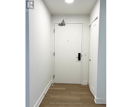 A white door with a black handle and a black lock.