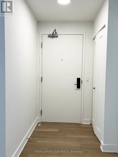 A white door with a black handle and a black lock.