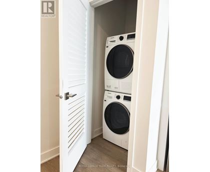 A white door with a washing machine behind it.