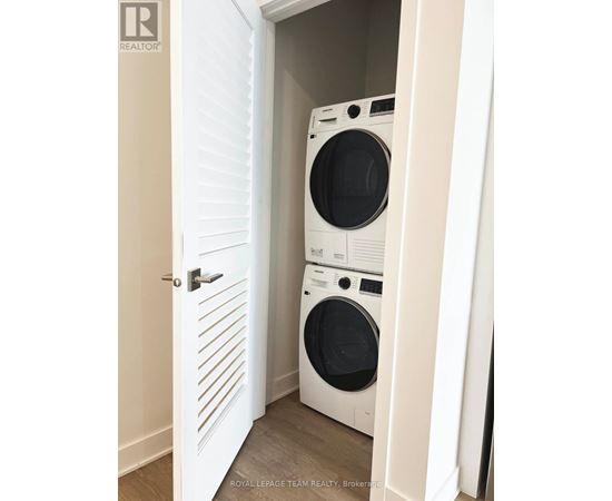 A white door with a washing machine behind it.