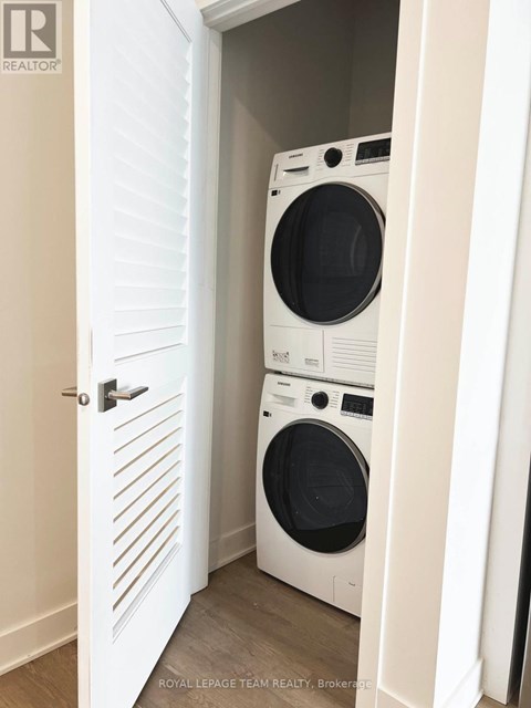 A white door with a washing machine behind it.