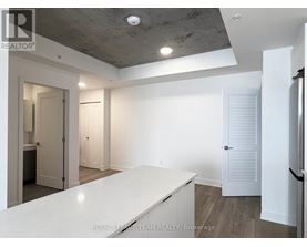 A spacious room with a white countertop and a ceiling with exposed beams.