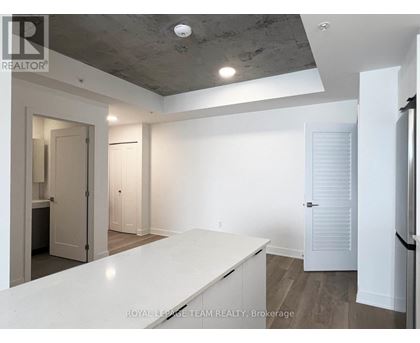 A spacious room with a white countertop and a ceiling with exposed beams.