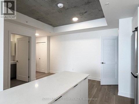 A spacious room with a white countertop and a ceiling with exposed beams.