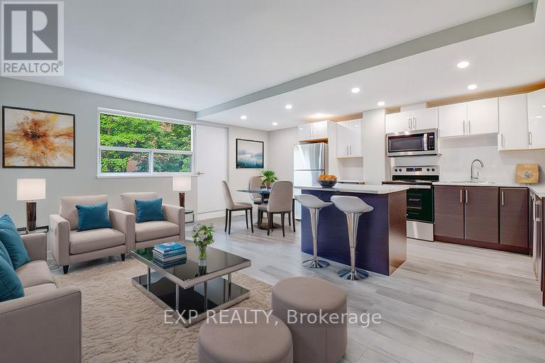 A modern living room with a kitchen area in the background.