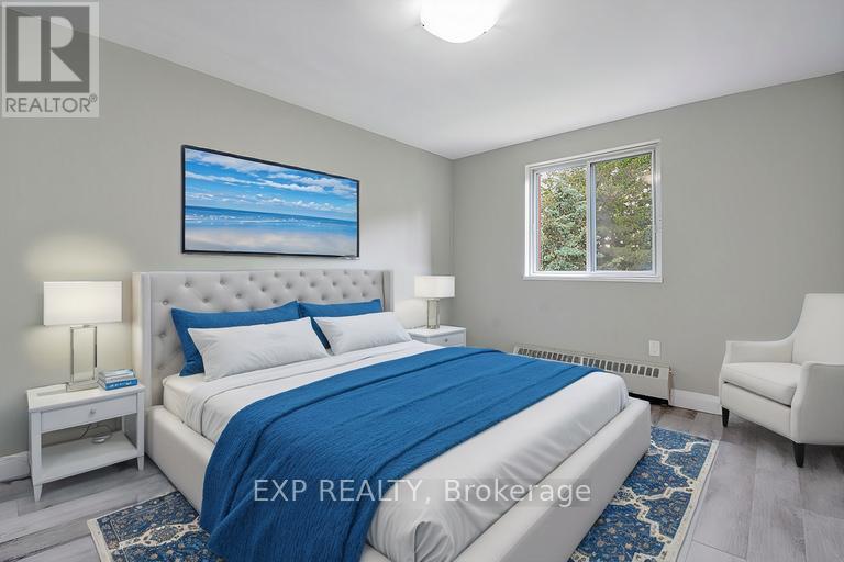 A bedroom with a large bed and a painting on the wall.