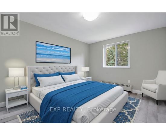 A bedroom with a large bed and a painting on the wall.
