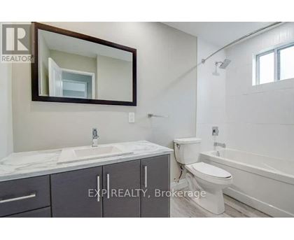 A bathroom with a sink, toilet, and bathtub.