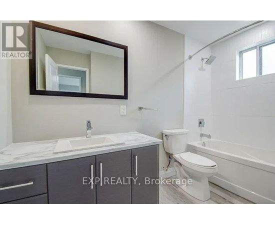 A bathroom with a sink, toilet, and bathtub.