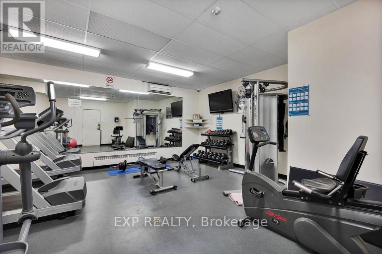 A gym with treadmills, weights, and exercise equipment.