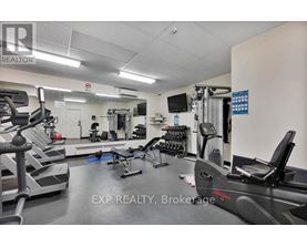 A gym with treadmills, weights, and exercise equipment.