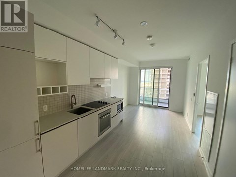 A kitchen with white cabinets and a black stove top oven.