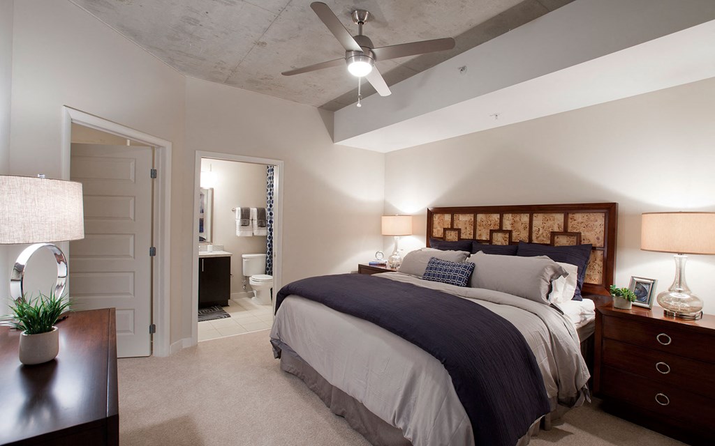 a bedroom with a bed and a ceiling fan