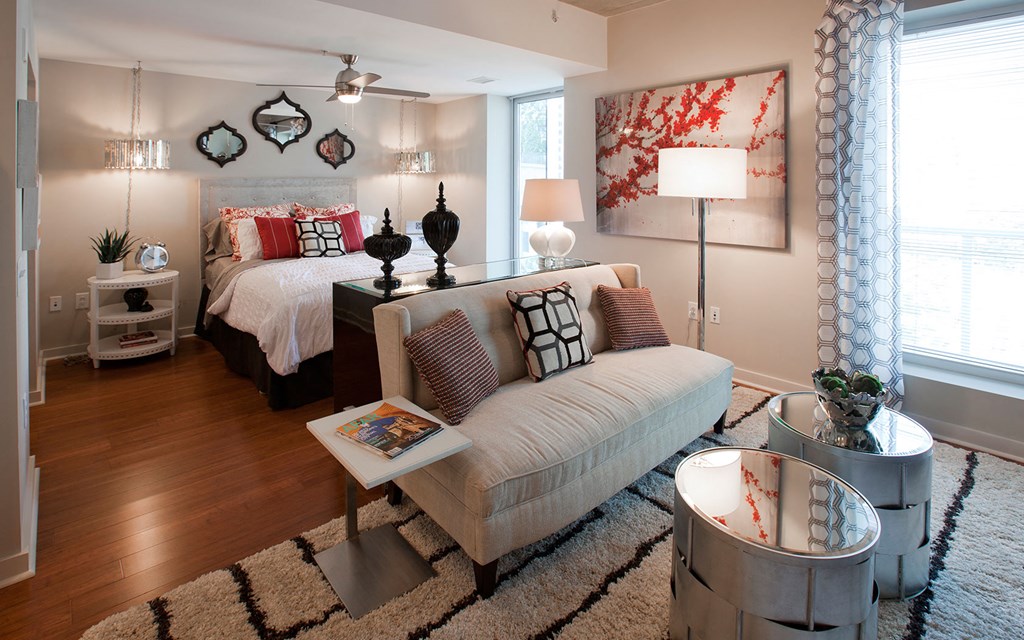 a bedroom with a couch and a bed in it