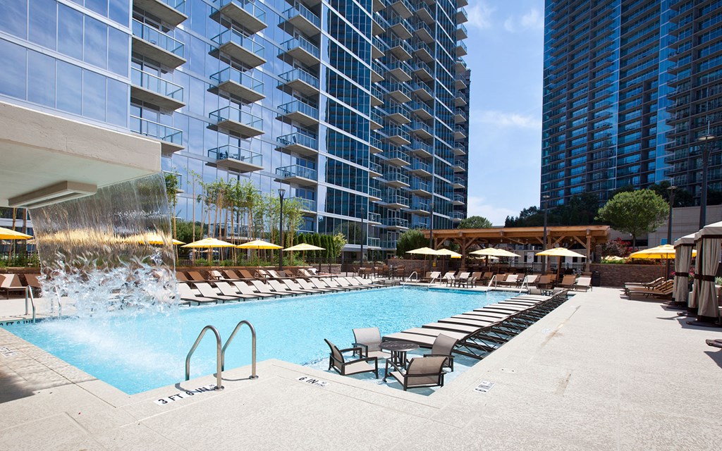 a swimming pool at a hotel with a water fountain