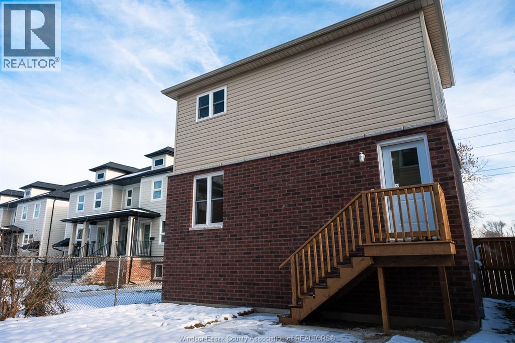 A house with a wooden deck in front of it.