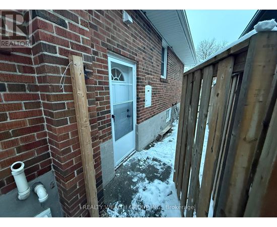A house with a white door and a brick wall.