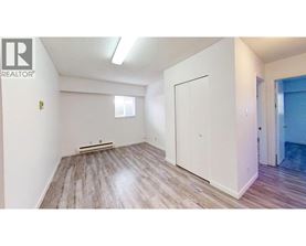 A room with a white door and a window with blinds.