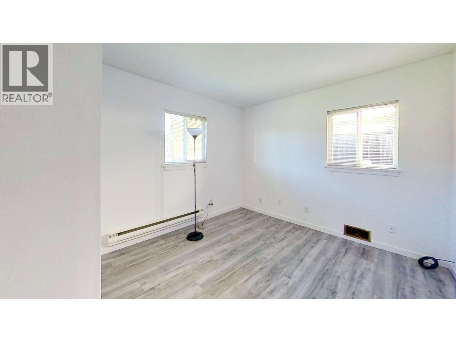 A room with a wooden floor and a window.