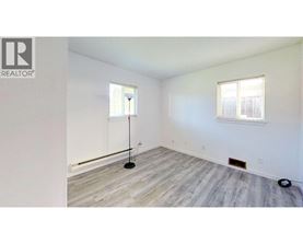 A room with a wooden floor and a window.