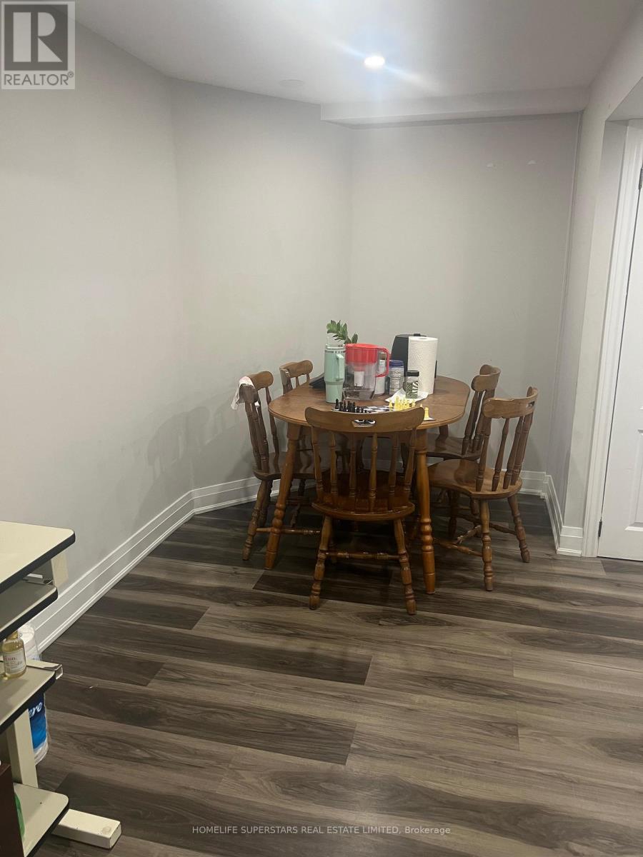 A dining room with a wooden table and chairs.