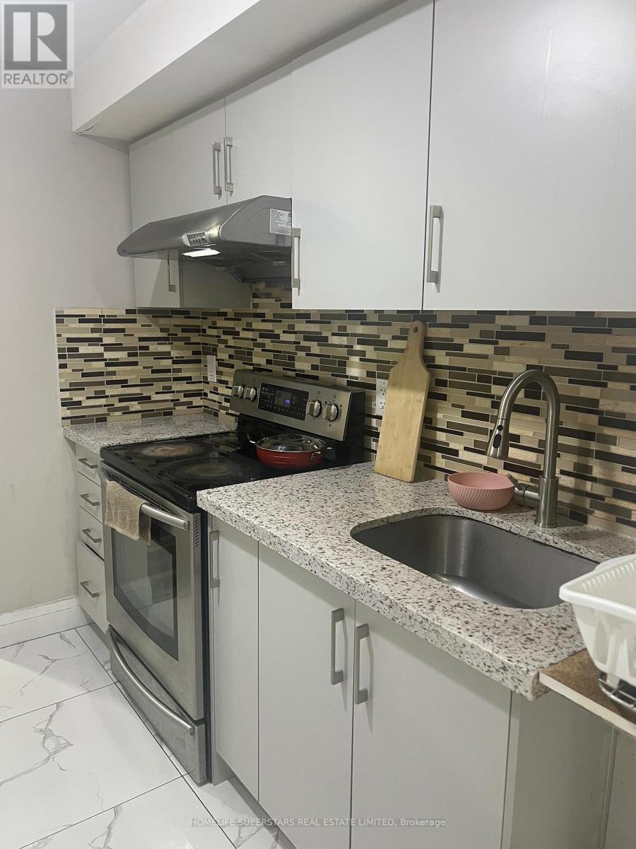 A modern kitchen with a stove, oven, and sink.